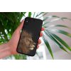 mockup of a woman holding a clear phone case in front of a houseplant 4636 el1 2023 03 30T112352.048