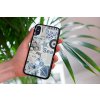 mockup of a woman holding a clear phone case in front of a houseplant 4636 el1 2023 06 20T144840.907