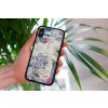 mockup of a woman holding a clear phone case in front of a houseplant 4636 el1 2023 06 20T145405.475