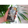 mockup of a woman holding a clear phone case in front of a houseplant 4636 el1 2023 06 20T153855.297