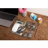 mockup of a mousepad lying on a rustic table next to a flower vase 27554