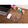 mockup of a mousepad lying on a rustic table next to a flower vase 27554