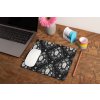 mockup of a mousepad lying on a rustic table next to a flower vase 27554