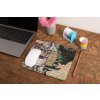 mockup of a mousepad lying on a rustic table next to a flower vase 27554 (1)