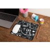 mockup of a mousepad lying on a rustic table next to a flower vase 27554