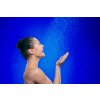Woman in shower blue background