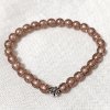 Korálkový náramek s kovovým doplňkem - měděná barva