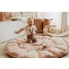 playandgo bloom fleuri babymat child sitting and laughing on open mat