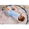 PlayandGo outdoor beachbag magical days child is lying on the bag in the sand enjoying the sun
