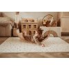 PlayandGo EEVAA treehouse puzzlemat child lying on a wooden swing board on the mat