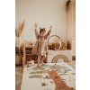 PlayandGo EEVAA treehouse puzzlemat child is standing on the mat with raised arms