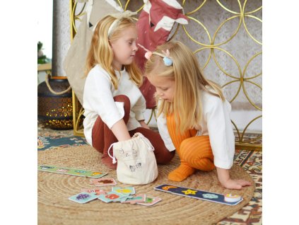 Dieťa sa hrá s dreveným senzorickým pexesom a puzzle na koberci