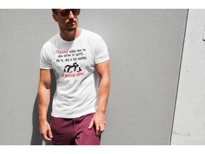 t shirt mockup of a muscular man posing against a wall 2245 el1