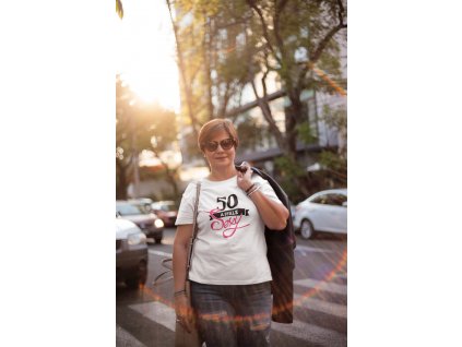 middle aged woman wearing a t shirt mockup carrying a jacket on her back a20719