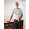 smiling man wearing a tshirt mockup holding a book in his house a20506