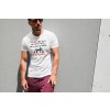t shirt mockup of a muscular man posing against a wall 2245 el1