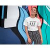 tee mockup of a smiling girl in front of a wall with colorful illustrations 26646