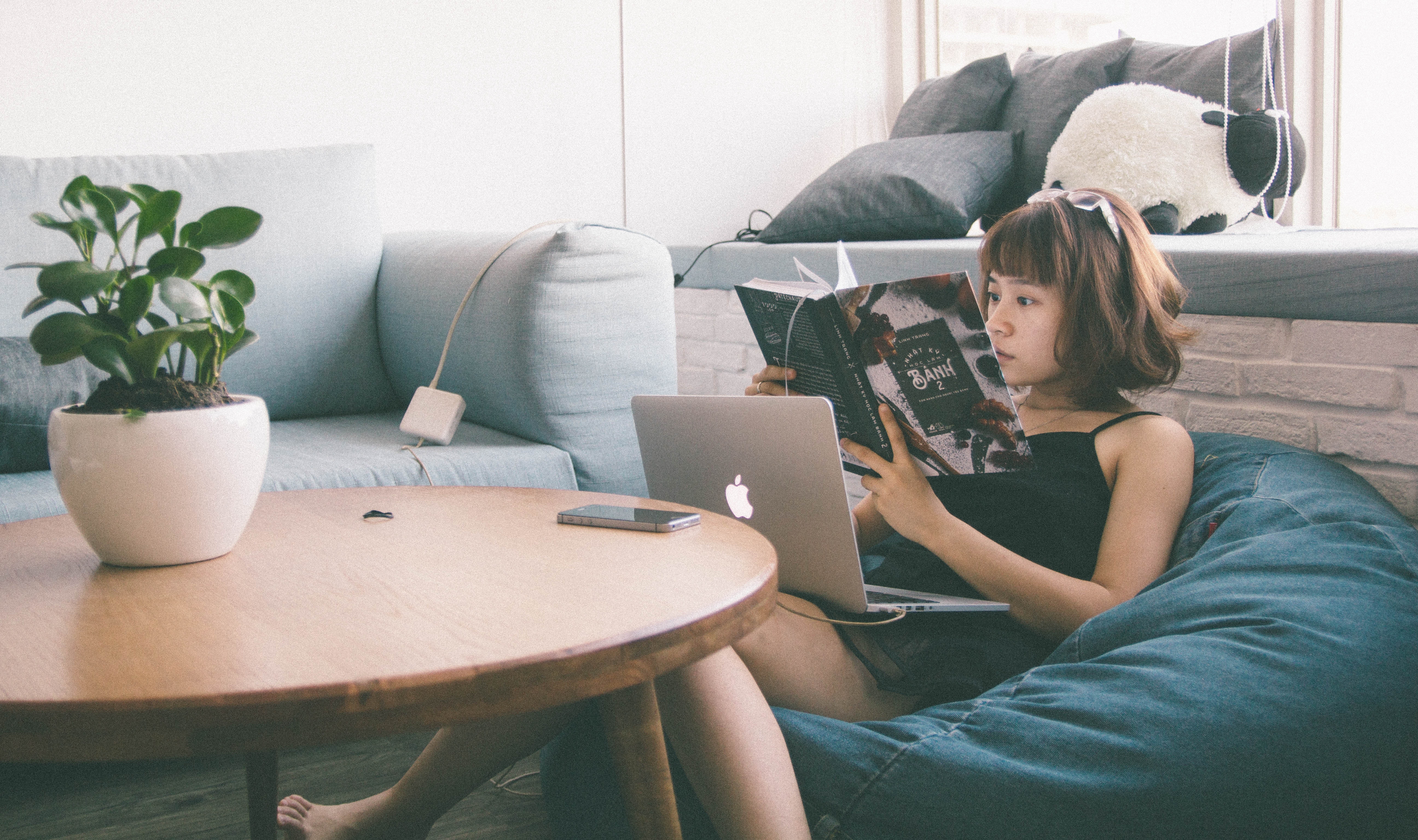 woman-sitting-on-bean-bag-white-using-macbook-in-front-of-169915