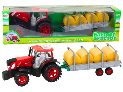 Zemědělský traktor s přívěsem a balíky sena červený