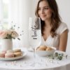 Romantic bridal shower scene, a personalized champagne flute with the word Nevesta (bride) standing elegantly on a white linen tablecloth, soft natural light streaming through sheer curtains onto a breakfast
