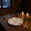 A rustic wooden dining table set for a cozy Christmas Eve dinner in a Scandinavian style cabin, a whimsical white plate with a hand painted flying pig and snowflake design at the center of the table, surround