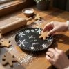 Close up lifestyle shot, Warm and inviting kitchen scene during the Christmas holidays; the black snowflake patterned plate is casually placed on a rustic wooden countertop dusted with flour, scattered amongs