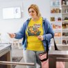 plus size tee mockup of a woman opening an automatic gate machine at the gym m21410 r el2