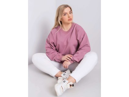 Modelka v ružovej oversize mikine plus size s bielymi nohavicami.