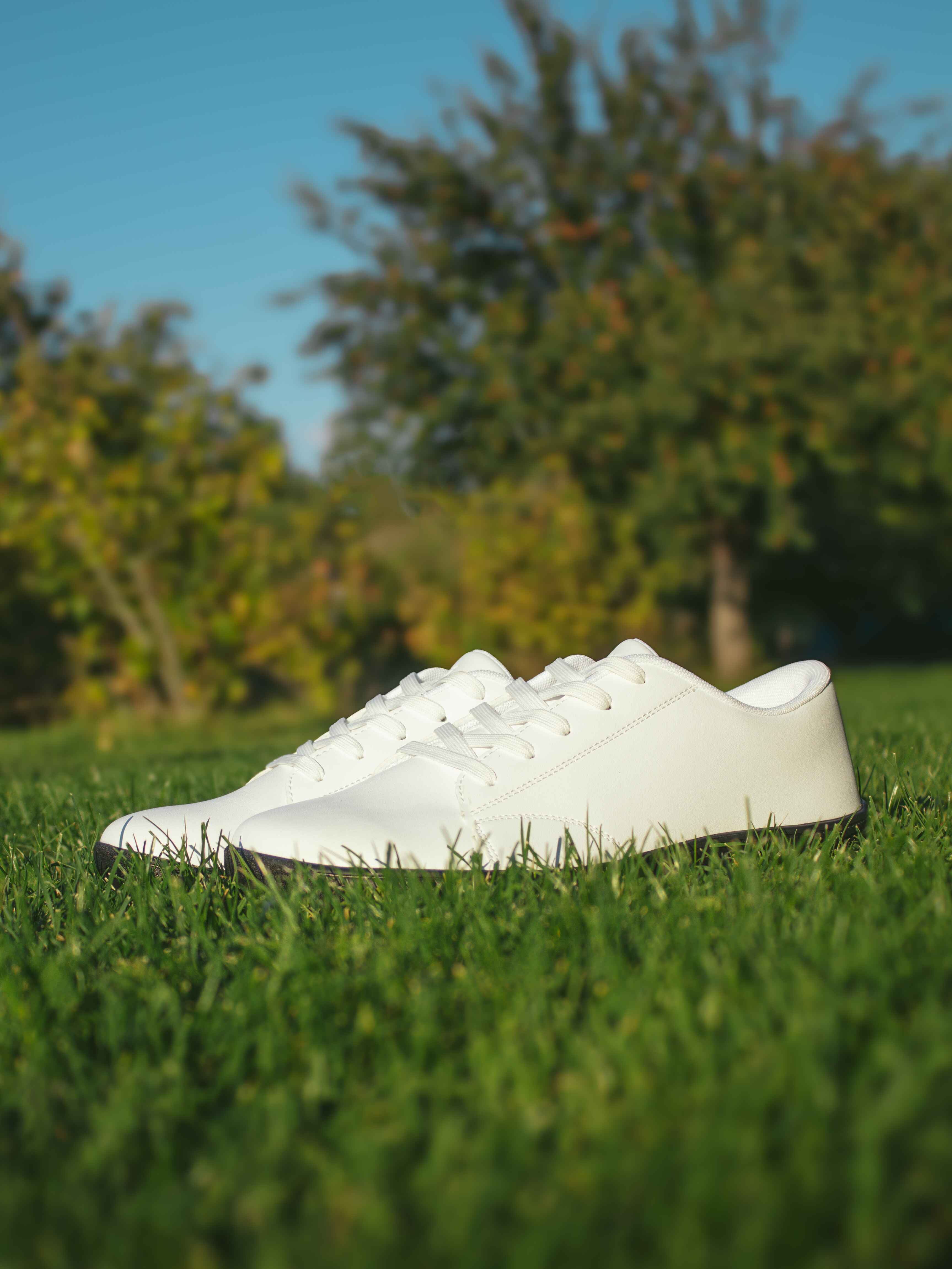 White Mitochondriak barefoot shoes on grass during grounding