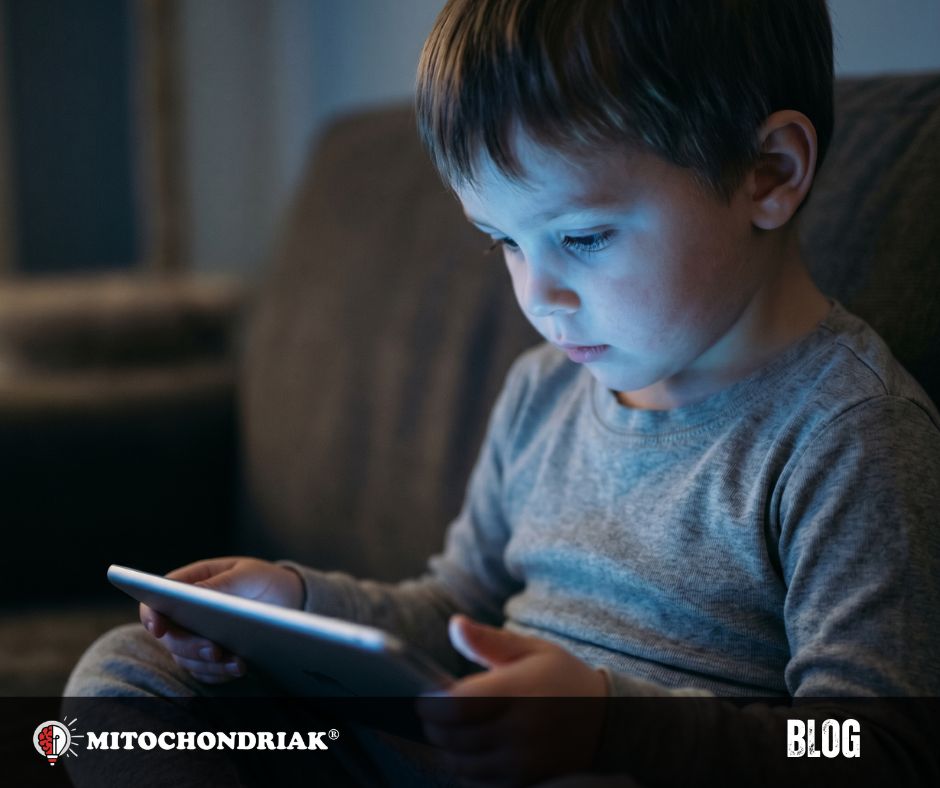 Child looking at tablet at night with blue light from screen