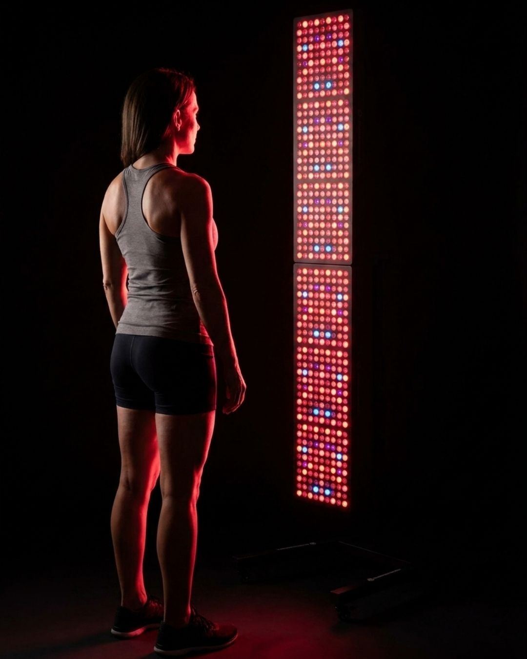 Woman during full-body therapy with a Maxi UVB panel tower for vitamin D