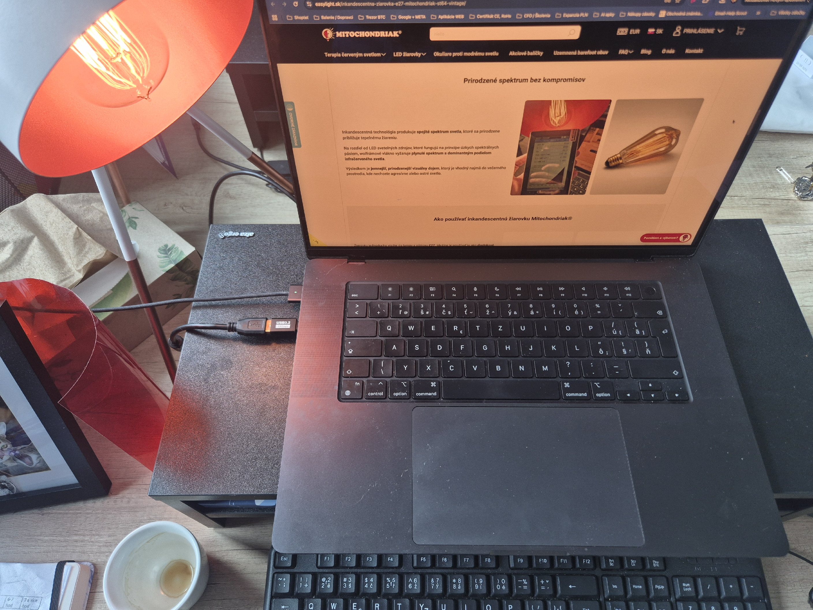 incandescent light bulb beside laptop and monitor