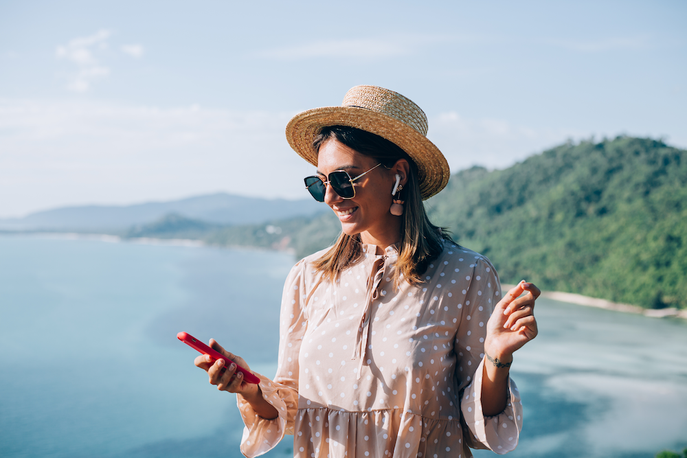 young-woman-summer-cute-dress-straw-hat-sunglasses-dancing-with-smartphone-hand-listening-music