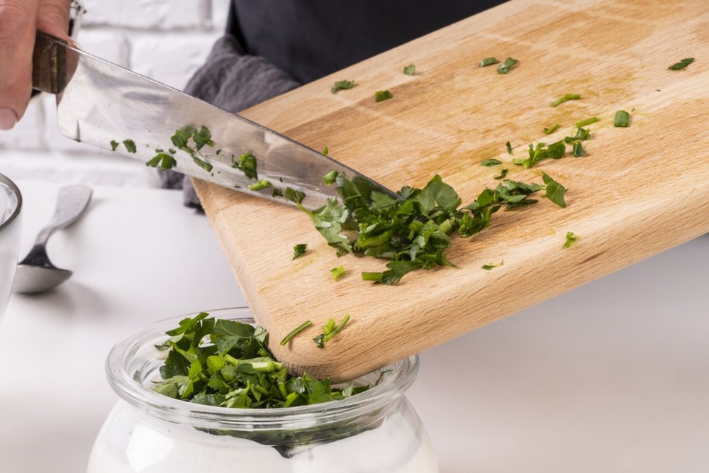 chef-adding-chopped-chives-dressing_resized