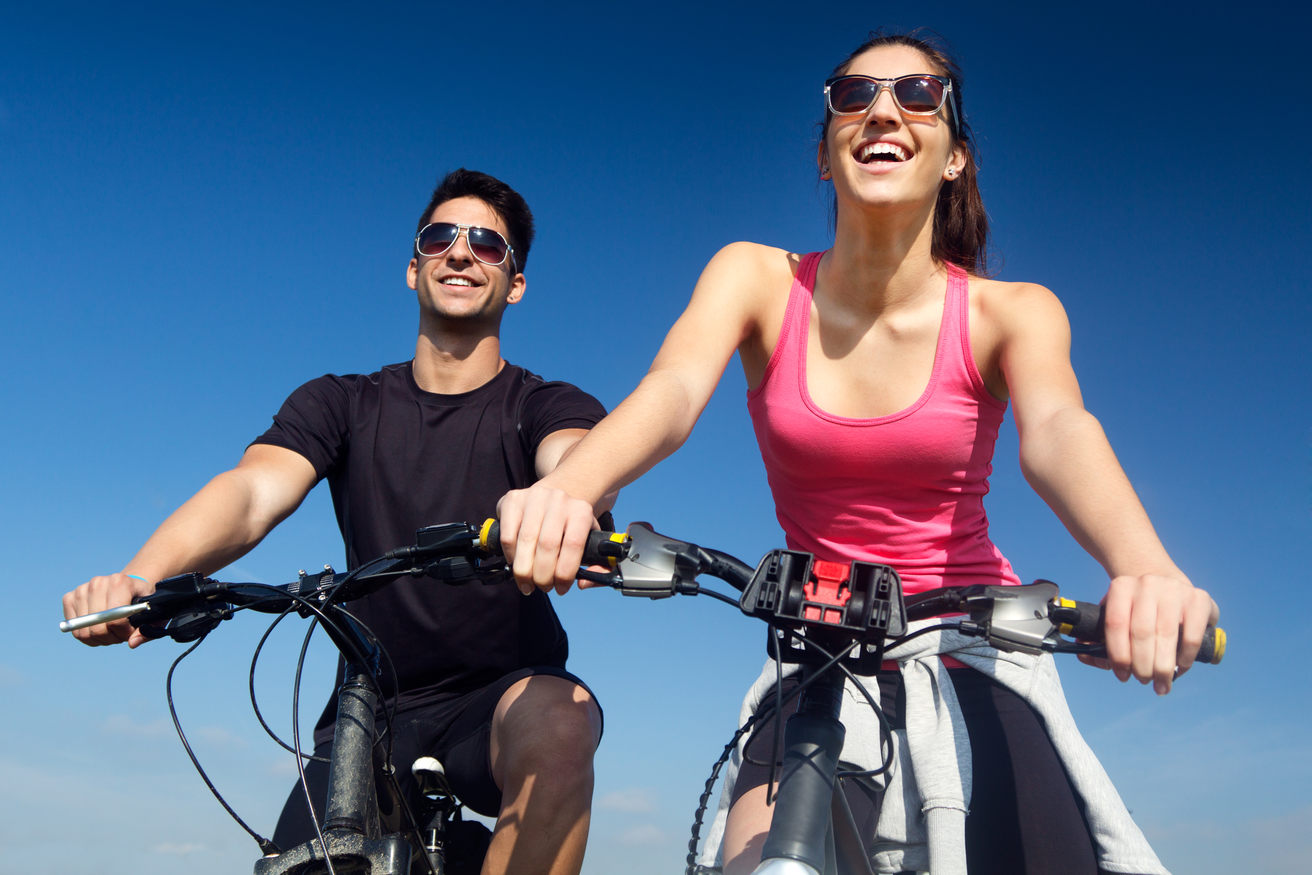 happy-young-couple-bike-ride-countryside