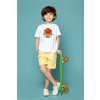 front view cute child boy white t shirt yellow jeans holding green skateboard blue floor 179666 1008