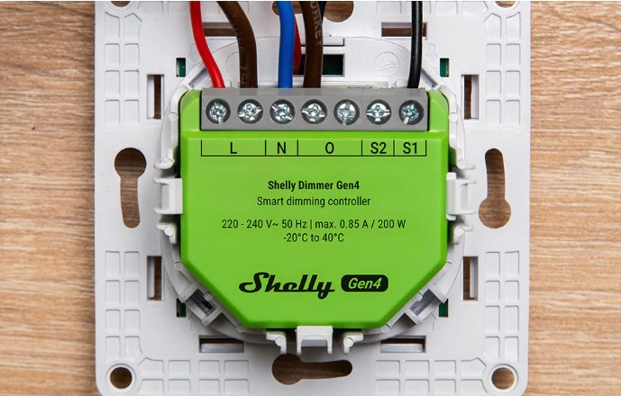 Shelly Dimmer Gen4 zapojený na instalační desce s připojenými vodiči pro stmívání osvětlení.
