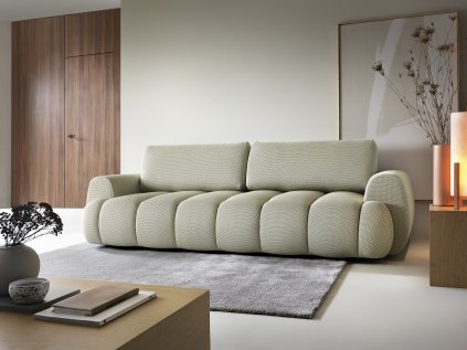 Rozkládací pohovka MODIVO SOFA v interiéru u stěny, světle zelené čalounění, pohled v úhlu zepředu.