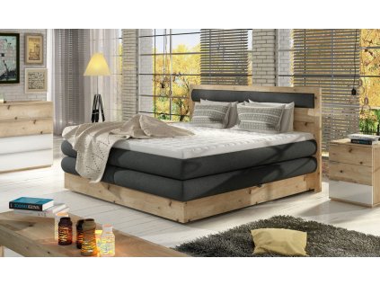 Boxspring postel LISA v interiéru ložnice, pohled z mírného úhlu, tmavě šedé čalounění, masivní dřevěná konstrukce