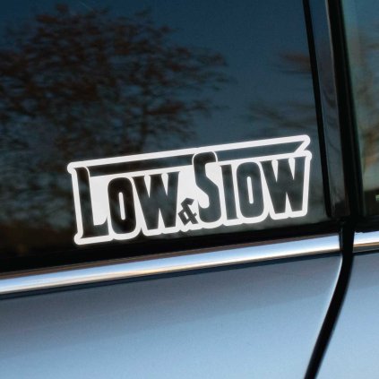 Plotrovaná nálepka na auto s nápisom „Low & Slow“ v štýle lowrider kultúry, doplnená o zvýraznenú hornú linku.