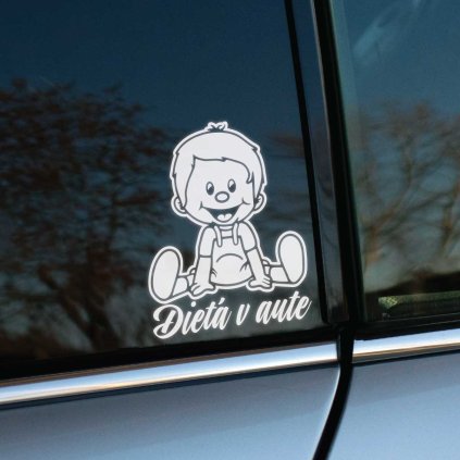 Plotrovaná nálepka s motívom usmiateho sediaceho chlapčeka v montérkach, doplnená o plynulý písaný nápis Dieťa v aute.