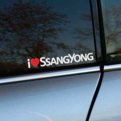 Plotrovaná nálepka s textom „I ♥ SSANGYONG“, kde červené srdiečko vyjadruje vášeň pre odolné SUV a off-road modely tejto značky. Skvelý doplnok pre fanúšikov.