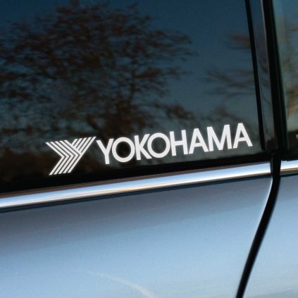 Plotrovaná nálepka s logom YOKOHAMA a šípovým motívom z čiar vľavo od názvu značky.