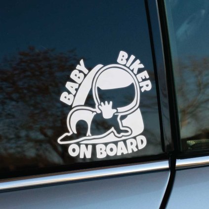 Plotrovaná nálepka na auto s nápisom „Baby Biker on Board“ a obrázkom ležiaceho dieťaťa v motorkárskej prilbe.