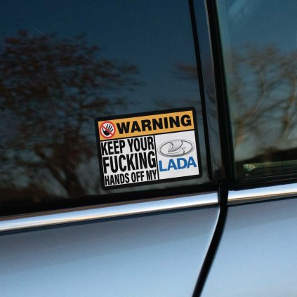 Tlačená obdĺžniková nálepka s textom KEEP YOUR FUCKING HANDS OFF MY LADA a preškrtnutým symbolom ruky ako jasné varovanie.