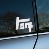 Biela nálepka so starým znakom "teq" na okne auta dodáva vozidlu retro štýl a jedinečný charakter. Tento dizajn, inšpirovaný historickým logom Toyoty, je perfektný pre automobilových nadšencov, ktorí oceňujú klasický vzhľad a originalitu. Nálepka vytvára zaujímavý kontrast na tmavom okne, čím okamžite priťahuje pozornosť. Ideálna pre tých, ktorí chcú vyjadriť svoju lásku k značke Toyota a jej bohatému dedičstvu.