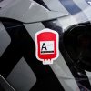 Tlačená nálepka v tvare krvného vaku s označením A− Rh NEGATIVE, určená na auto, motorku alebo prilbu pre núdzovú identifikáciu.