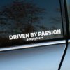 Plotrovaná nálepka s hlavným nápisom DRIVEN BY PASSION, pod ktorým je menší text v znení: Simply More.. v druhom rade.
