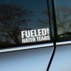 Plotrovaná nálepka Fueled by Hater Tears s výrazným rozložením slov a zvislým "BY", vhodná na zadné alebo bočné sklo auta.