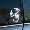 Plotrovaná nálepka na auto s geometricky štylizovaným škorpiónom, výrazné klepetá a chvost zahnutý do oblúka.